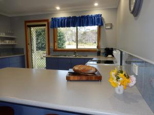 a kitchen with a counter with a sink and a window at Holiday home by the beach in St Helens in St Helens