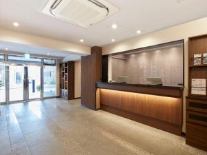 a lobby with a reception desk in a building at HOTEL MYSTAYS Kiyosumi Shirakawa in Tokyo