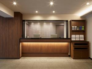a waiting room with a podium with two laptops at HOTEL MYSTAYS Kiyosumi Shirakawa in Tokyo