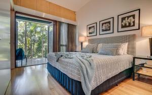 a bedroom with a bed and a large window at Noosa Residences in Noosa Heads
