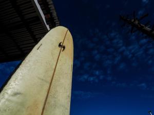 une planche de surf accrochée au ciel dans l'établissement Cabañas Costa Blue, à Pichilemu