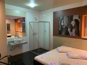 a bathroom with a bed and a sink and a mirror at IBIZA GOLDEN MOTEL in Franca +85 photos
