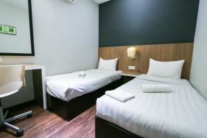 Ένα ή περισσότερα κρεβάτια σε δωμάτιο στο Hotel 99 Botanik Klang