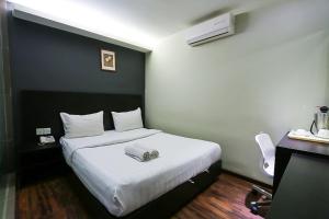 Voodi või voodid majutusasutuse Hotel 99 Bandar Klang (Meru) toas