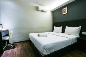 Voodi või voodid majutusasutuse Hotel 99 Bandar Klang (Meru) toas