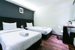 Voodi või voodid majutusasutuse Hotel 99 Bandar Klang (Meru) toas