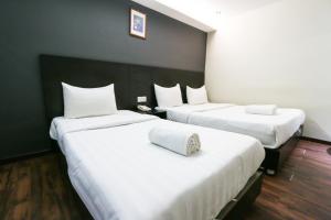 Voodi või voodid majutusasutuse Hotel 99 Bandar Klang (Meru) toas