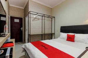 Rúm í herbergi á RedDoorz Plus near Lippo Cikarang Mall