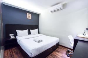 Voodi või voodid majutusasutuse Hotel 99 Bandar Klang (Meru) toas