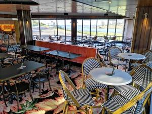 a restaurant with tables, chairs, tables and chairs at The Sebel Harbourside Kiama in Kiama