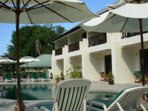 a resort with chairs and umbrellas and a swimming pool at residence papillon in Thong Son Beach
