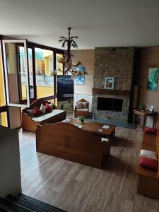a living room with a couch and a fireplace at Appartement Cauterets in Cauterets