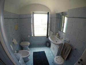 W łazience znajduje się umywalka, toaleta i umywalka. w obiekcie Villa La Mura w mieście Atrani
