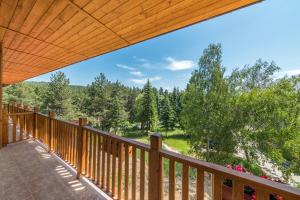 a deck with a view of the woods at SPA Hotel Elbrus in Velingrad