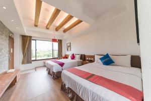 a hotel room with two beds and a window at THE ONE-Liuqiu in Xiaoliuqiu +54 photos