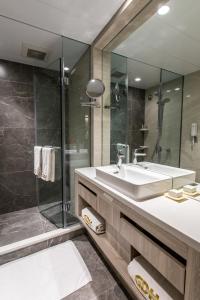 a bathroom with a sink and a shower at Wharney Hotel in Hong Kong