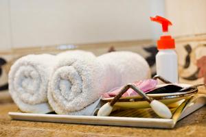 a pile of towels on a counter with a sink at Prakash Kutir B&B in New Delhi