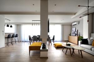 a living room with a couch and a table at Urban Melodies Apartment in Athens