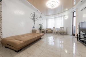 a large living room with a large bed and a television at Fresh Arcadia Apartments in Odesa