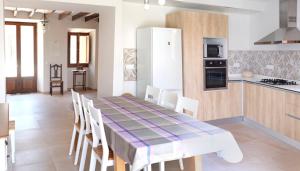 a kitchen and dining room with a table and chairs at Can Calet in Marratxí 