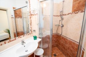 a bathroom with a sink and a shower at Covo dei Saraceni in Polignano a Mare
