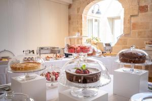 a kitchen with cakes and other desserts on display at Covo dei Saraceni in Polignano a Mare