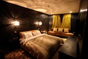 a bedroom with a large bed and a couch at Riad Dar Haven in Tamraght Ou Fella