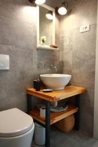 a bathroom with a sink and a toilet at Tramontana Leeward - Cozy and charming apartment in beautiful Volosko in Opatija