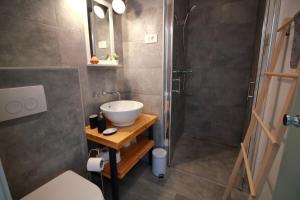 a bathroom with a sink and a shower at Tramontana Leeward - Cozy and charming apartment in beautiful Volosko in Opatija +12 photos