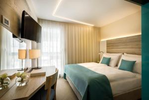 A bed or beds in a room at Hotel Marina - Liburnia