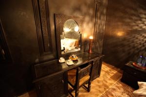 a bathroom with a vanity with a mirror and a sink at Riad Dar Haven in Tamraght Ou Fella