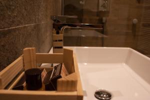 a bathroom with a bath tub with a sink at Chalet Remì - Parè in Livigno