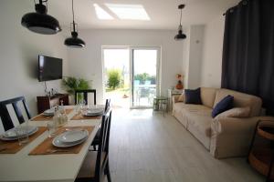 a living room with a table and a couch at Tramontana Leeward - Cozy and charming apartment in beautiful Volosko in Opatija