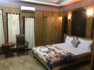 a bedroom with a bed and a desk and a chair at Nhật Vân 1 in Ho Chi Minh City