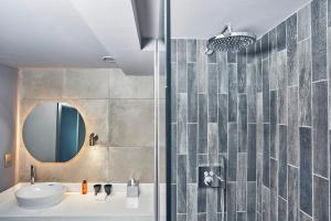 a bathroom with a sink and a shower at Malmaison Edinburgh City in Edinburgh