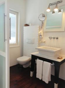 a bathroom with a sink and a toilet at 4reasons hotel + bistro | 12+ in Yalıkavak