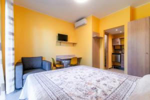 a bedroom with a bed and a chair and a table at Casa Livio - Rooms and studios in Como