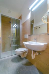 a bathroom with a sink and a toilet and a shower at Casa Livio - Rooms and studios in Como