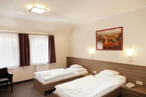 Łóżko lub łóżka w pokoju w obiekcie Paprika M1 Hotel