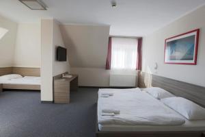 Łóżko lub łóżka w pokoju w obiekcie Paprika M1 Hotel