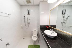 a bathroom with a toilet and a sink at Chiang Mai Mansion in Chiang Mai