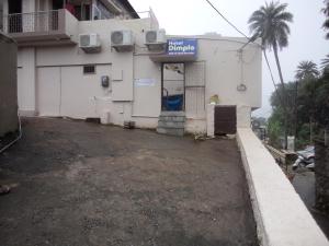 an empty parking lot in front of a building at Hotel Dimple in Mount Ābu