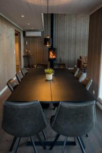 a conference room with a large wooden table and chairs at Furetoppen Panorama in Stryn
