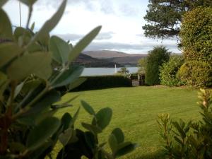 a garden with a view of the water and mountains at Buccleuch Guest House in Fort William