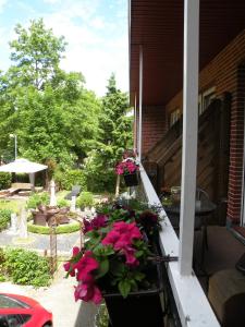a balcony with flowers on the side of a house at Hotel Garni Kröger in Wittmund
