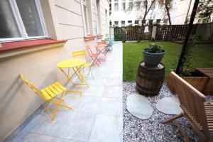 
a patio with chairs and a fire hydrant at Prague Dream Hostel in Prague
