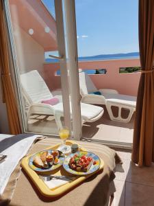 a tray of food on a table on a boat at Penthouse Christina with Pool - Large Sunny Terrace - Seaview - 250m to Beach and Restaurants - Free Parking - Trogir and Ciovo - 15 minutes to airport in Trogir