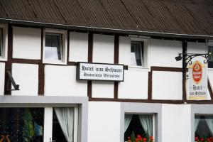 a sign on the side of a building at Hotel zum Schwan in Weilerswist