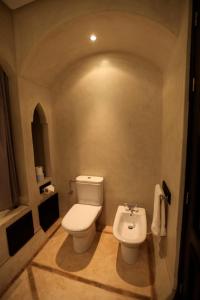 a bathroom with a white toilet and a bidet at Riad Dar Haven in Tamraght Ou Fella