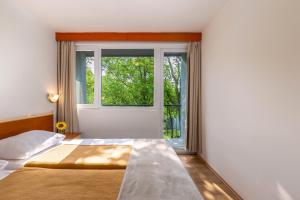 Postel nebo postele na pokoji v ubytování Holiday Resort Kačjak